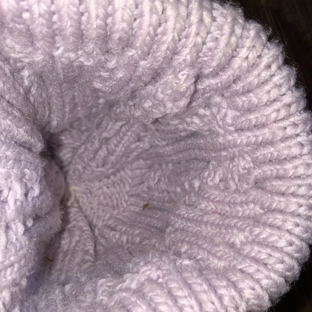 The north face lavender color beanie hat with large fluff Pom Pom